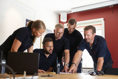 Firefighters talking in office