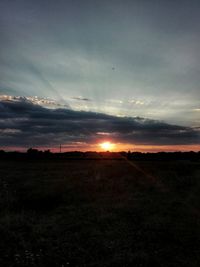 Scenic view of field against sky during sunset