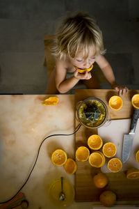 Boy eating oranges