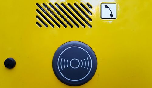 Close-up of yellow information sign