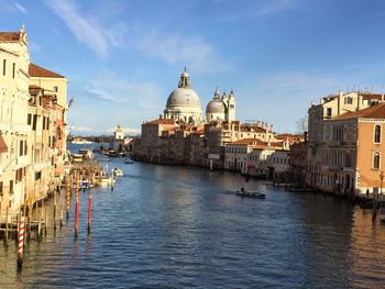 Panoramic view of canal and cathedral in city against sky