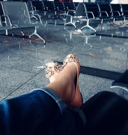 Low section of woman sitting on chair