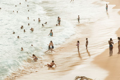 Large group of people on paciencia beach in the rio vermelho neighborhood of salvador, brazil. 