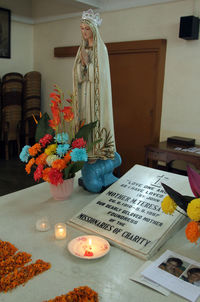 Statue of people on table at home