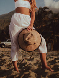 Full length of woman standing at beach