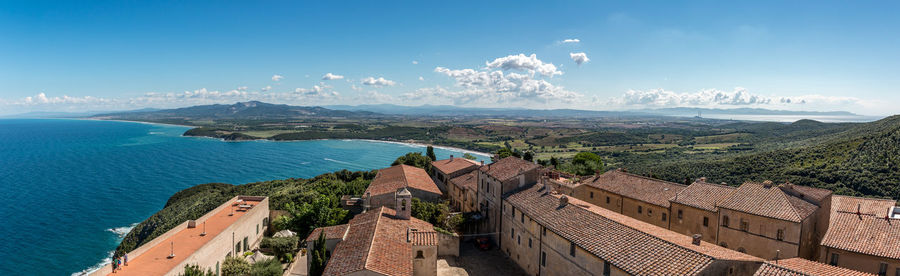 High angle view of buildings by sea against sky