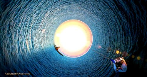 Close-up of illuminated light against blue sky