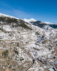 Scenic view of snowcapped mountains against blue sky