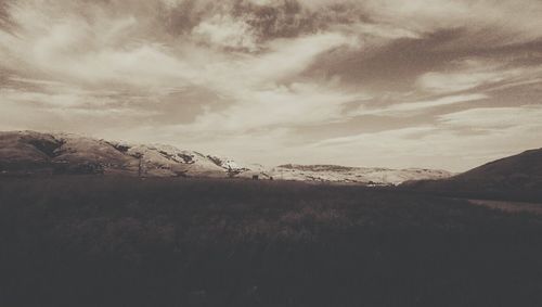 Scenic view of landscape against cloudy sky