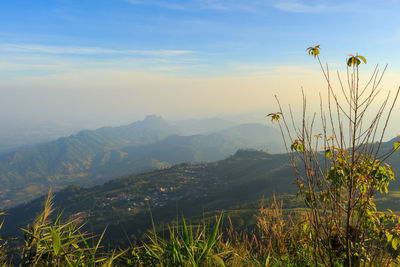 Scenic view of sea and mountains against sky