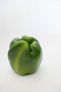 Close-up of green pepper over white background