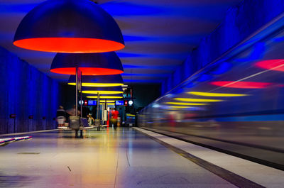 Blurred motion of illuminated subway station at night