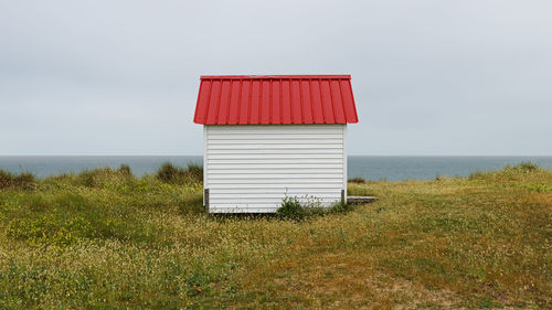 Lifeguard hut at beach against sky