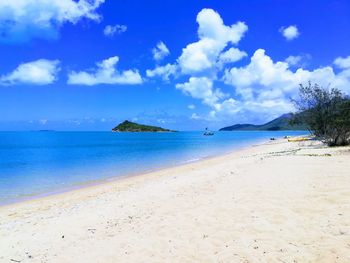 View of beach against cloudy sky