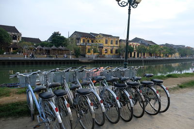Bicycles parked in row against sky
