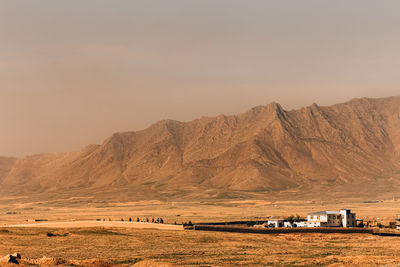 A large house and a mountain in the background. a large house near kabul, afghanistan. detached.