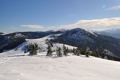 Scenic view of snow covered mountains against sky