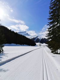 Snow covered landscape against sky