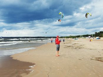 People on beach against sky