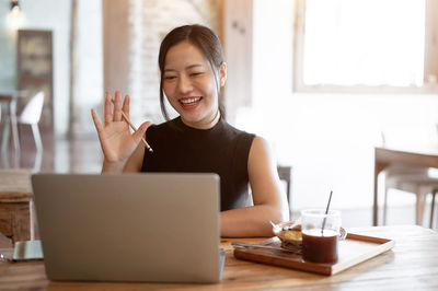 Businesswoman using laptop at table