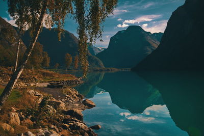 Scenic view of lake and mountains against sky