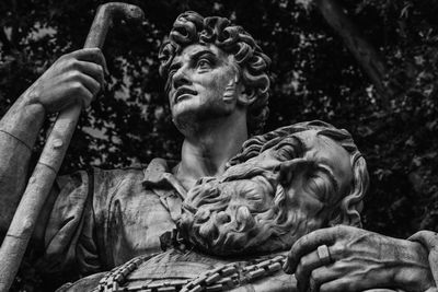 Low angle view of statue against plants