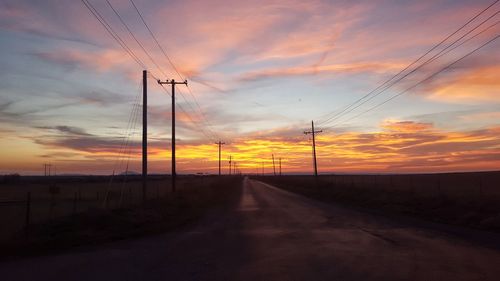 Road against dramatic sky during sunset