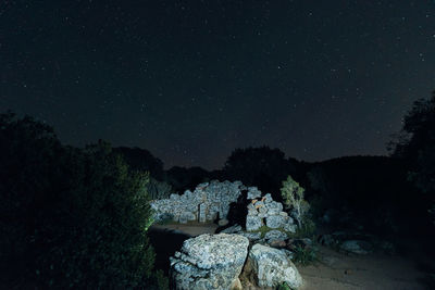 Scenic view of rock against sky at night