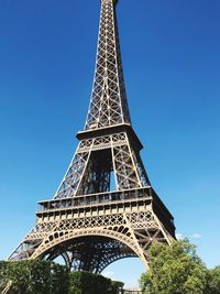 Low angle view of eiffel tower against blue sky