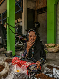 Portrait of woman sitting on street