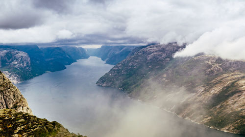 Scenic view of sea and mountains against sky