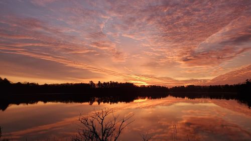 Scenic view of lake against romantic sky at sunset