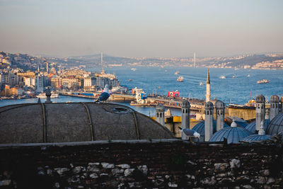 High angle view of buildings by sea against sky