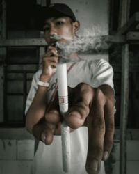 Portrait of young man smoking