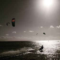 People on sea against sky