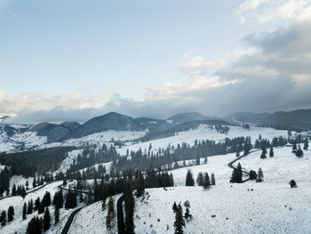 Scenic view of snow covered mountains against sky