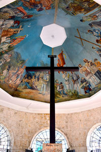 Low angle view of illuminated lighting equipment hanging on ceiling