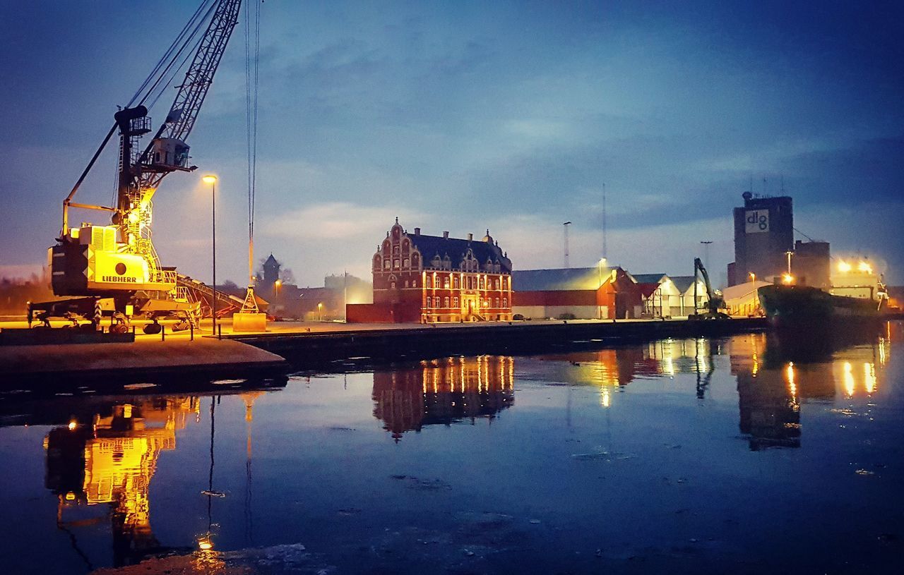 REFLECTION OF ILLUMINATED BUILDING IN WATER