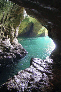 Scenic view of rock formation in water against sky