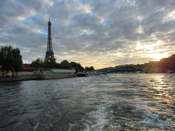 Eiffel tower against cloudy sky