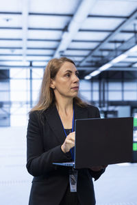 Portrait of young businesswoman using digital tablet