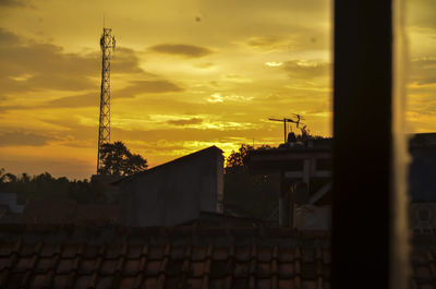 Silhouette buildings against sky during sunset