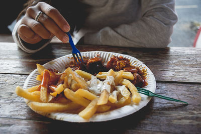 Close-up of hand holding food on table