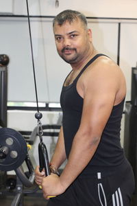 Portrait of man exercising at gym