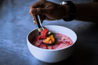 High angle view of hand holding ice cream in bowl