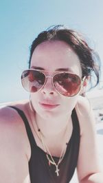 Close-up portrait of young woman wearing sunglasses