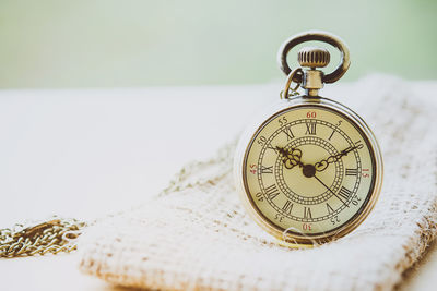 Close-up of pocket watch on table