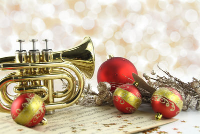 Close-up of trumpet and christmas decorations against defocused background