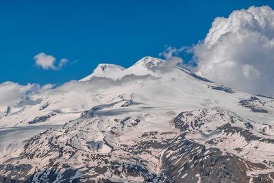 Scenic view of snow covered mountains against sky