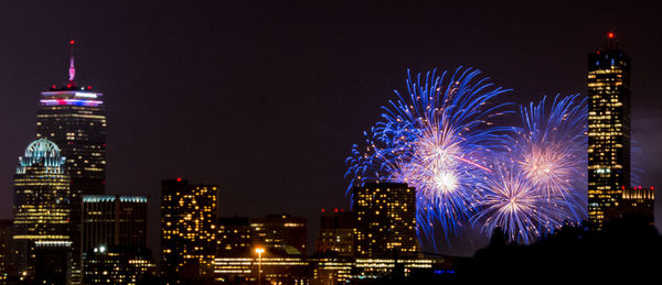 View of illuminated cityscape with firework